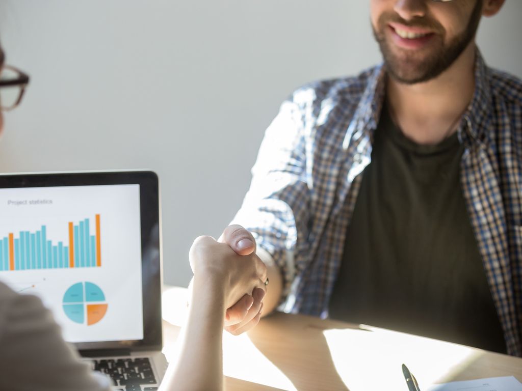 two-businesspeople-shake-hands-seal-deal-with-smile (1) two-businesspeople-shake-hands-seal-deal-with-smile (1)
